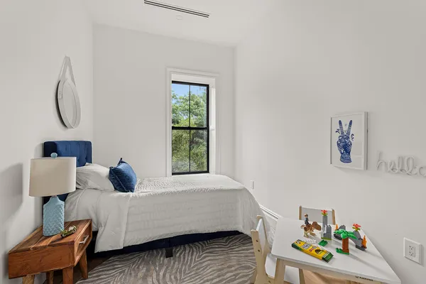 a bedroom with a bed and a window