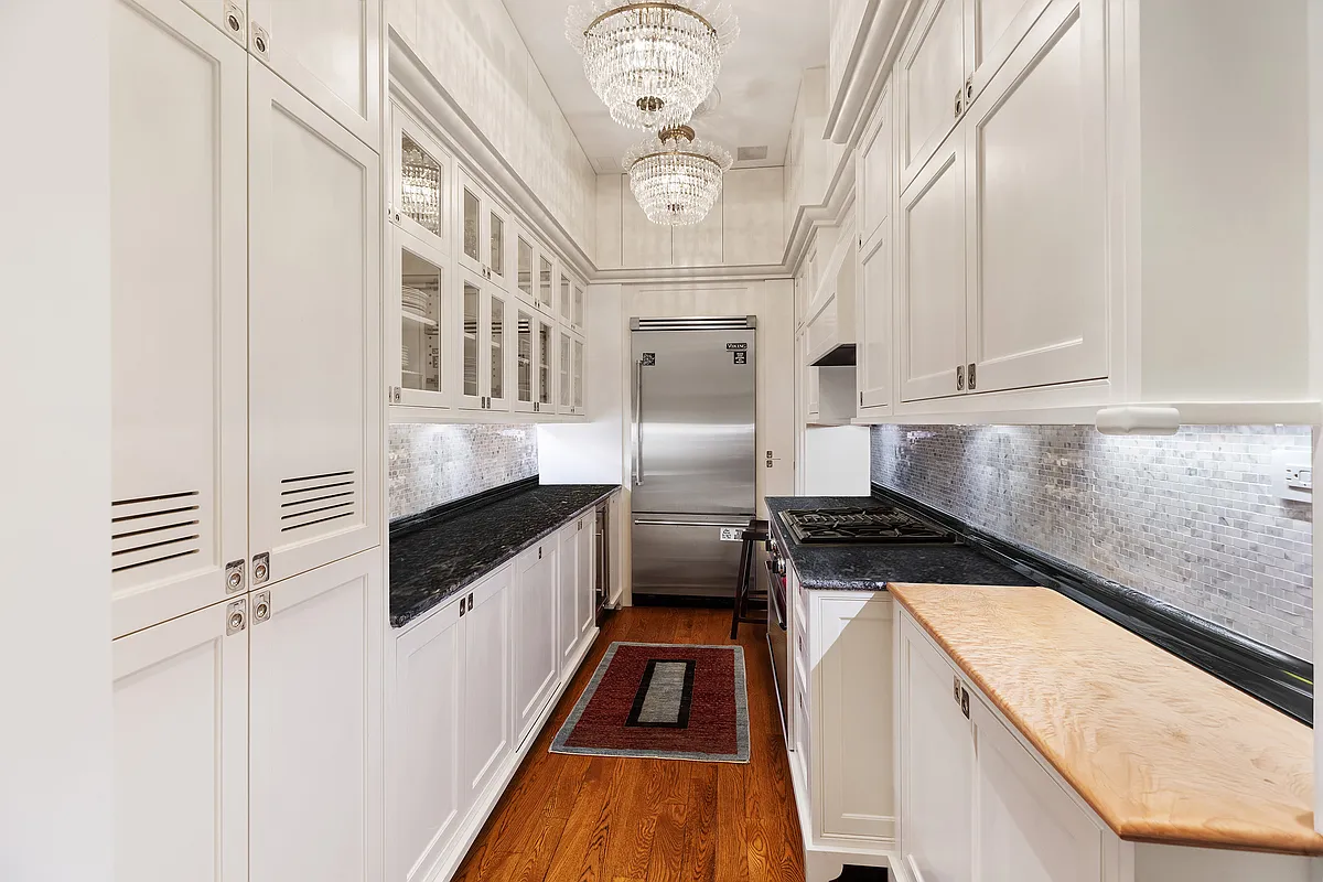1 Central Park South, Unit 8010203 Manhattan, NY 10019 - Photo 41 of 45 a kitchen with stainless steel appliances granite countertop a stove and a refrigerator