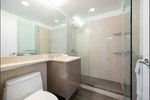 a bathroom with a sink toilet and shower