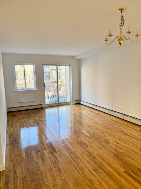 30-18 33rd Street, Unit 2F Queens, NY 11102 - Photo 1 of 6 wooden floor in an empty room with a window