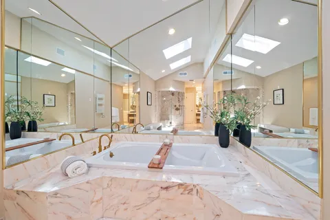 a bathroom with a toilet sink shower and mirror