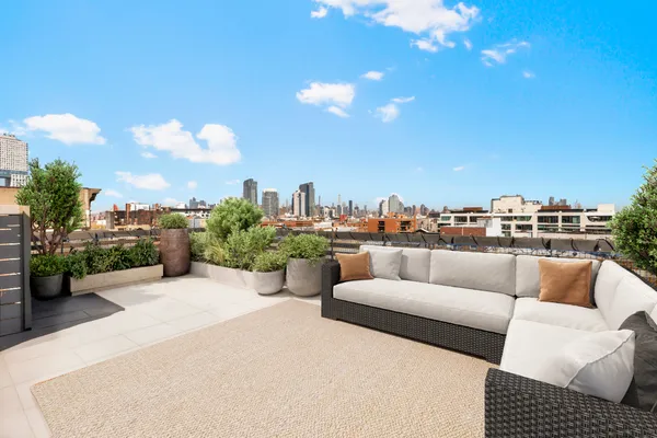a view of a terrace with couches and sky view