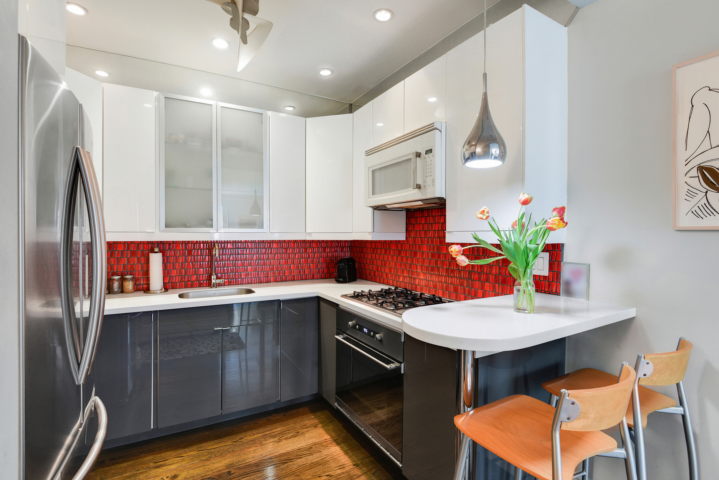 253 West 16th Street, Unit 3A Manhattan, NY 10011 - Photo 5 of 13 a kitchen with stainless steel appliances granite countertop a sink stove and refrigerator