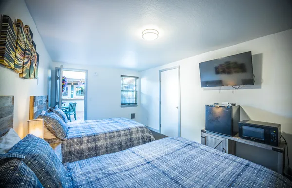 a bedroom with a large bed and a desk