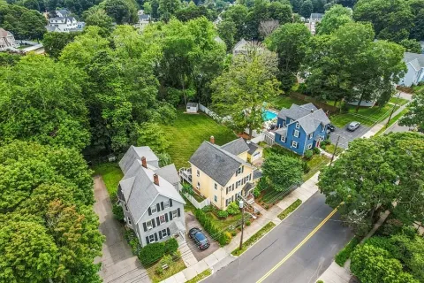 an aerial view of a house with garden space and street view