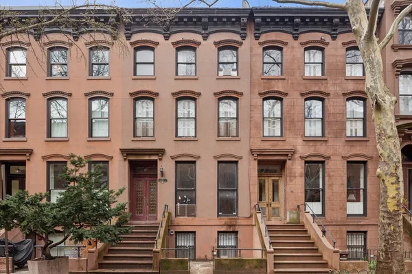 front view of a brick building with a lot of windows