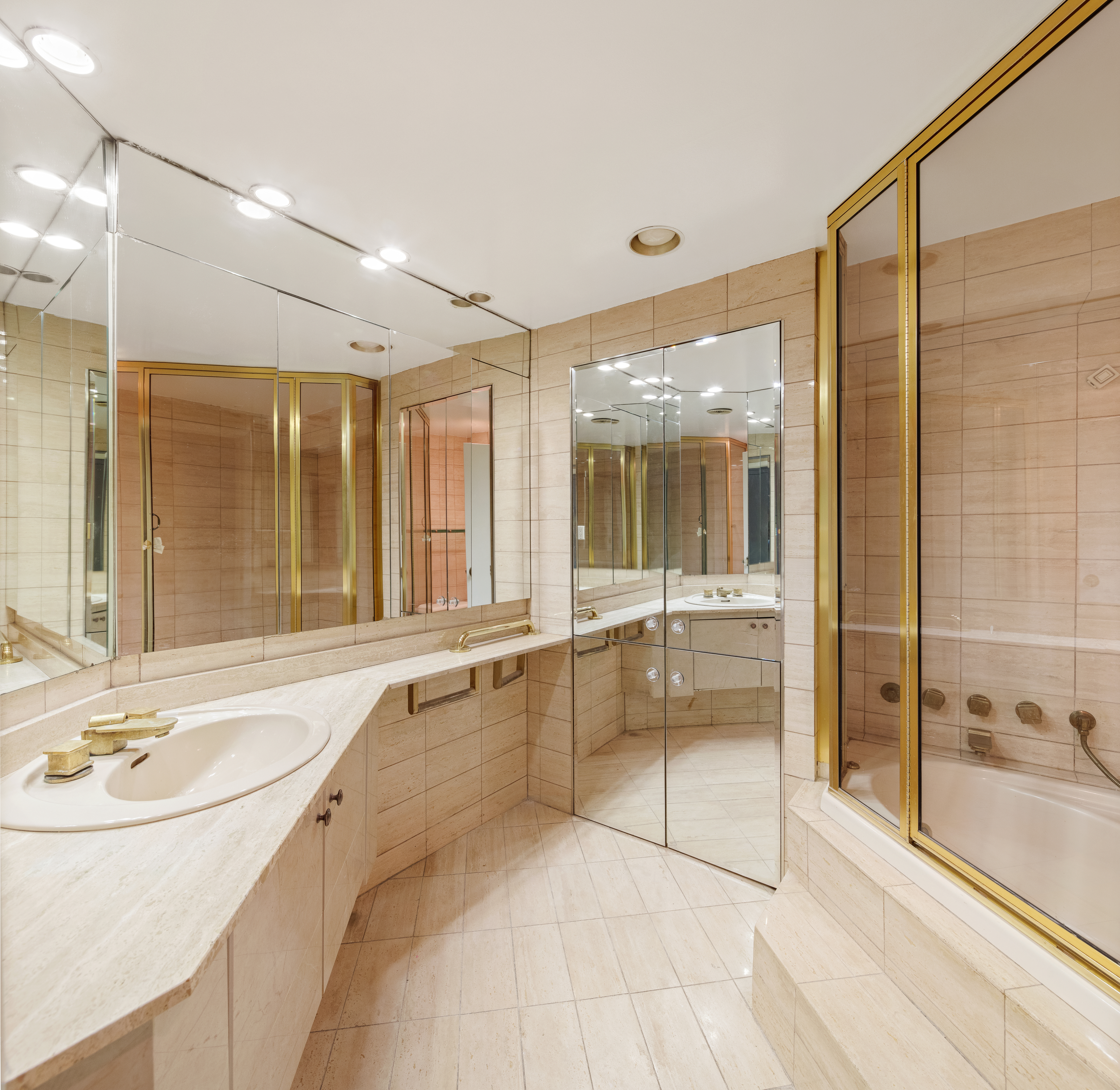 11 5th Avenue, Unit 5LW Manhattan, NY 10003 - Photo 8 of 19 a bathroom with a tub sink shower and mirror