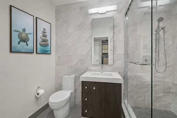 a bathroom with a toilet sink and mirror