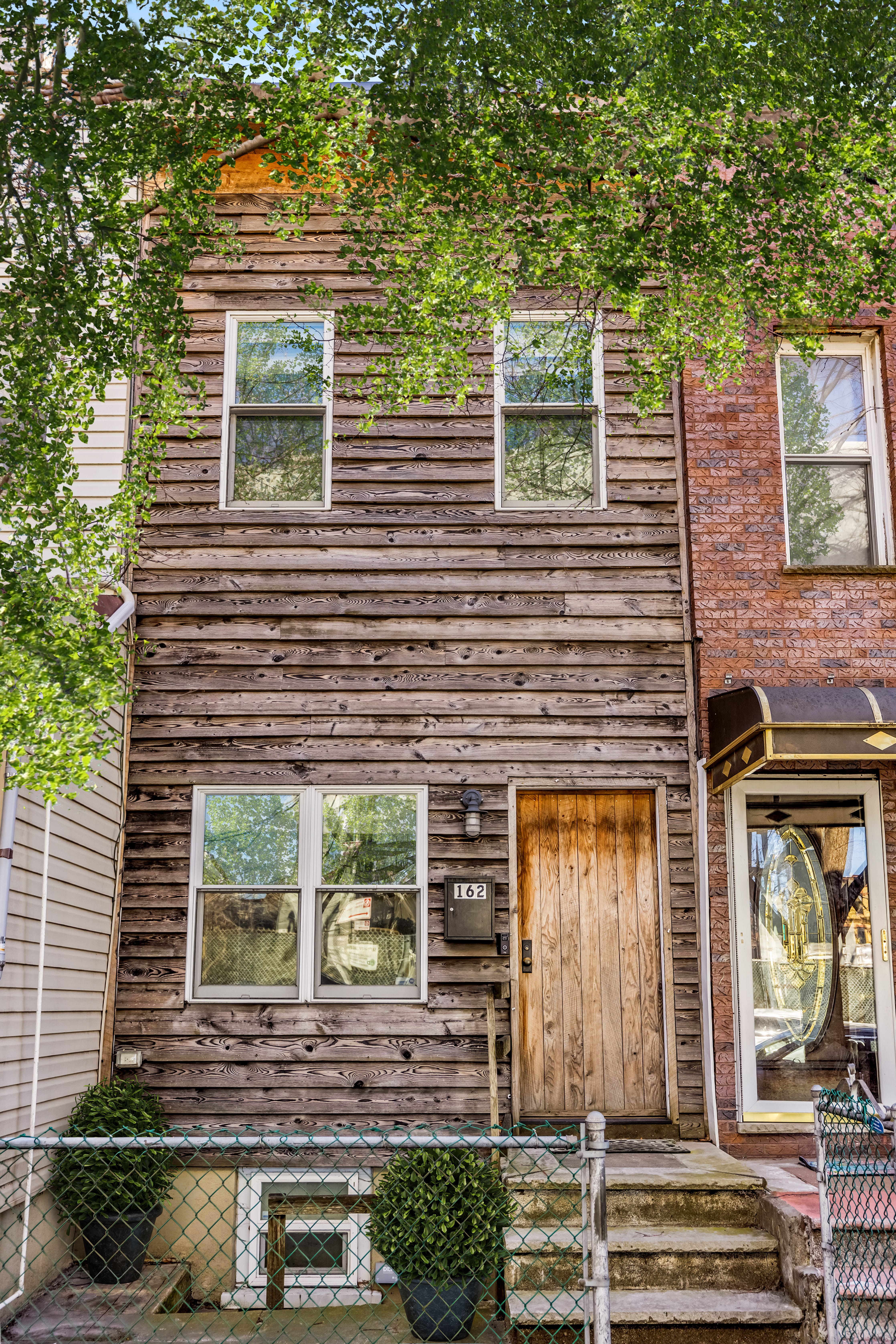 162 10th Street Brooklyn, NY 11215 - Photo 12 of 13 a front view of a house with a yard