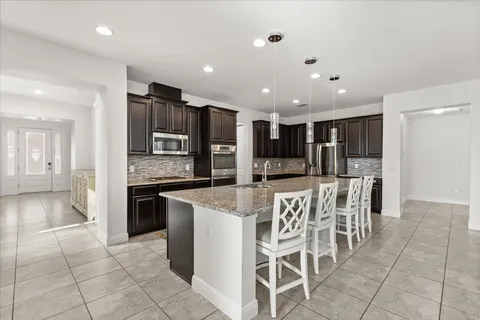 a view of a dining room with furniture wooden floor and chandelier