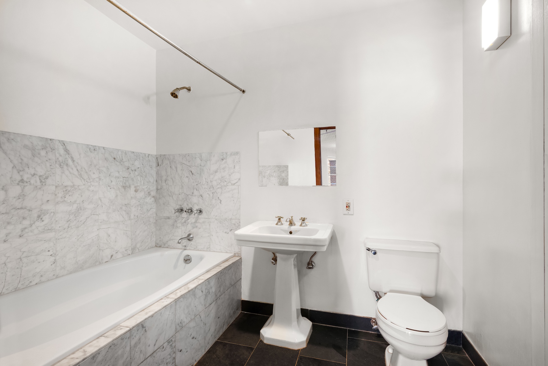 27 Bleecker Street, Unit 6B Manhattan, NY 10012 - Photo 5 of 7 a bathroom with a sink a toilet and shower