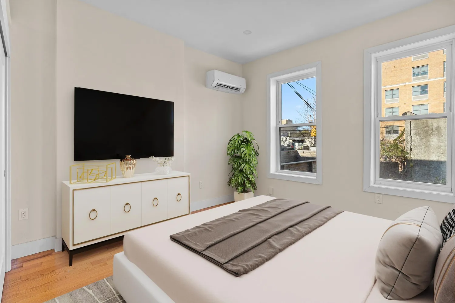 a living room with flat screen tv and a dresser