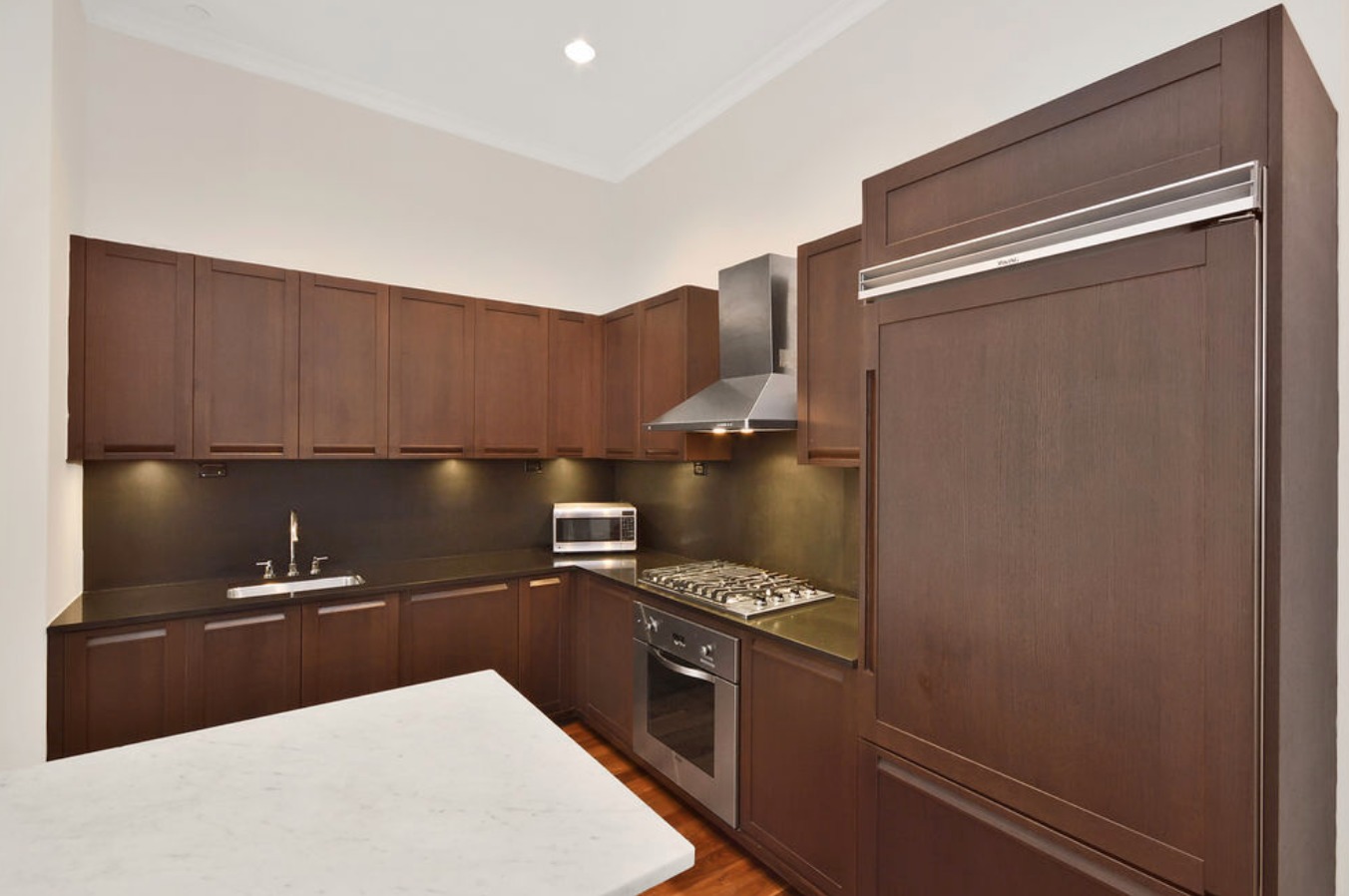 655 6th Avenue, Unit 4A Manhattan, NY 10010 - Photo 2 of 6 a kitchen with a refrigerator and a stove