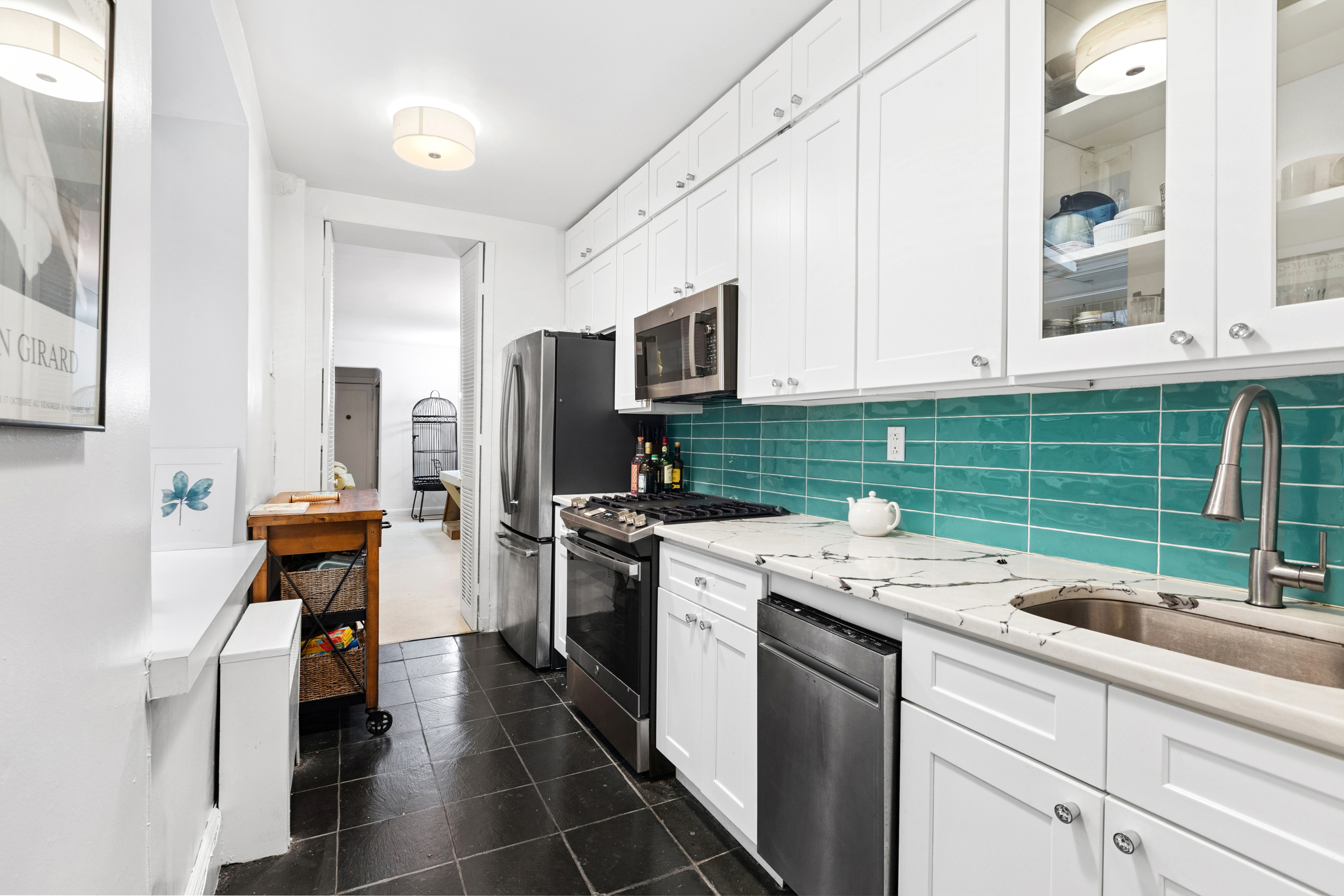 50 East 83rd Street, Unit 1R Manhattan, NY 10028 - Photo 4 of 12 a kitchen with a refrigerator and a sink