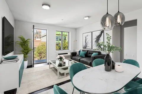 a living room with furniture a large window and a flat screen tv