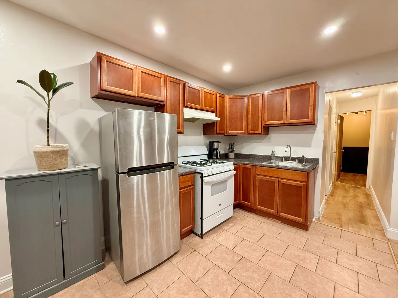 a kitchen with stainless steel appliances granite countertop a refrigerator sink and cabinets