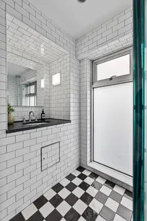 a bathroom with a sink mirror and shower