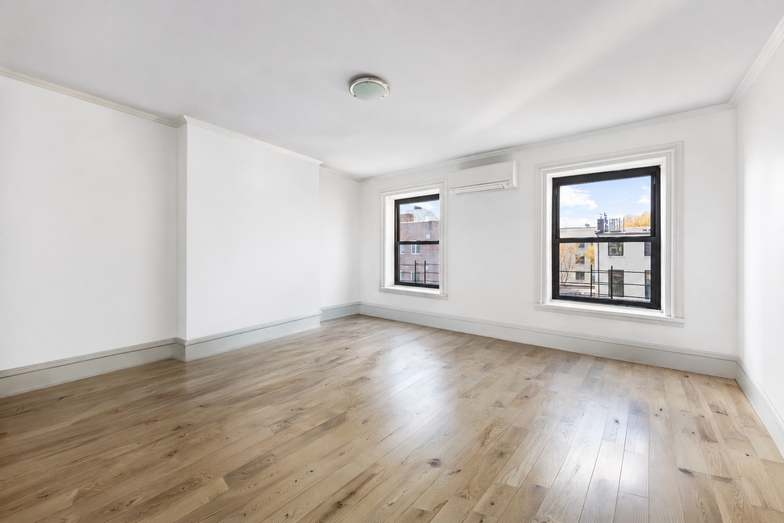 50 Wyckoff Street, Unit 2 Brooklyn, NY 11201 - Photo 13 of 14 a view of an empty room with wooden floor and a window