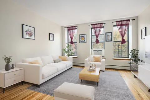 a living room with furniture or couch and a potted plant