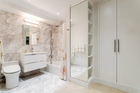 a bathroom with a sink toilet and shower