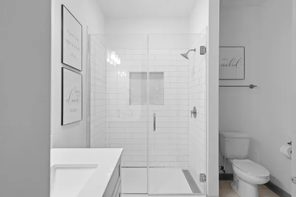 a bathroom with a shower and toilet