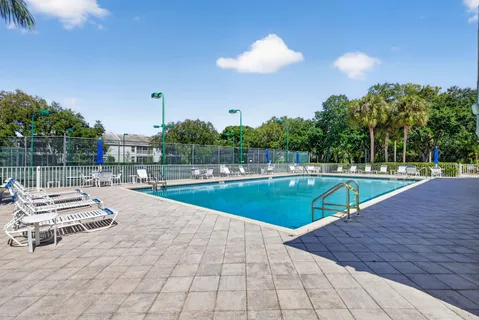 a view of a swimming pool with lounge chairs