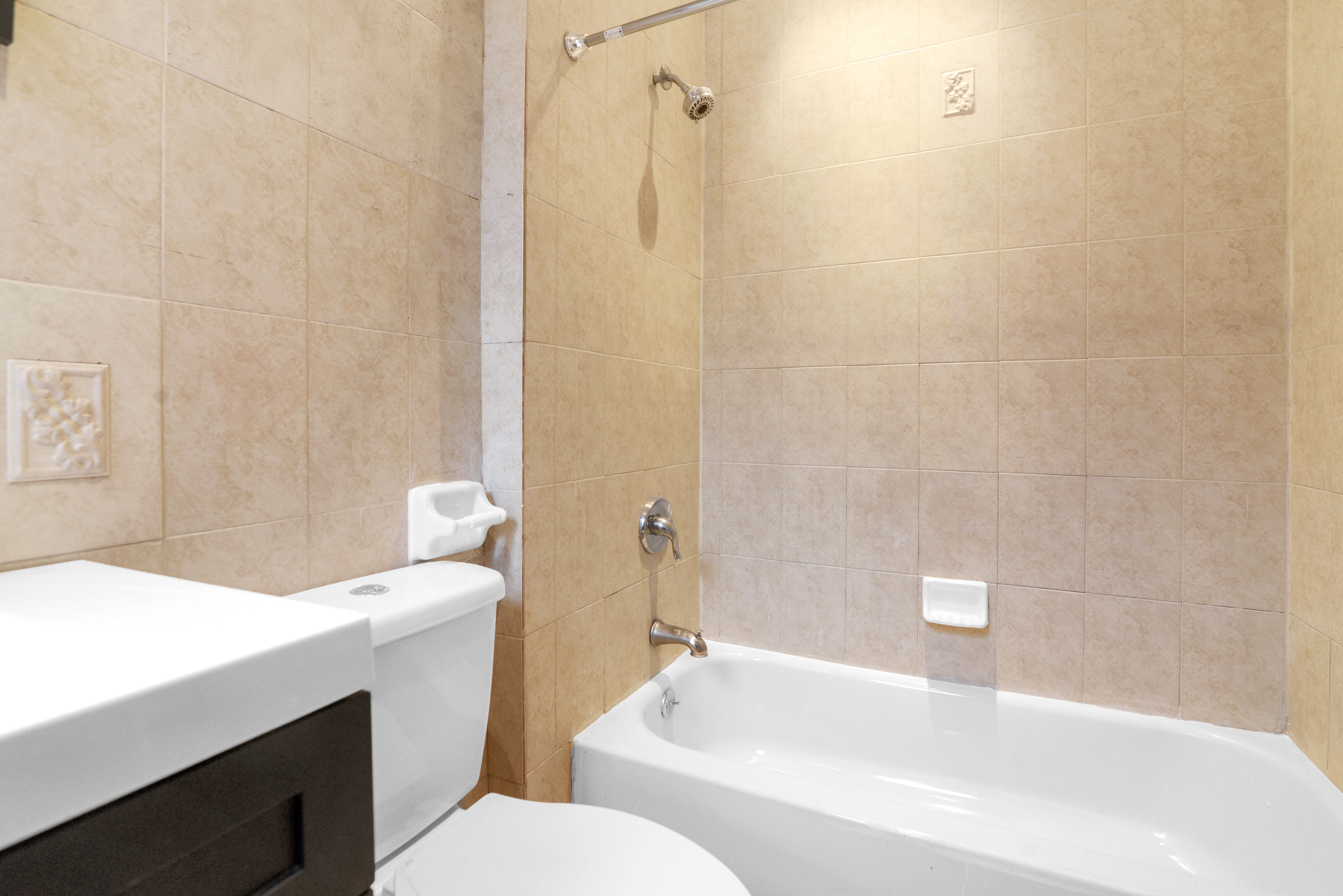2302 Bedford Avenue, Unit 3 Brooklyn, NY 11226 - Photo 21 of 25 a bathroom with a sink a toilet and shower