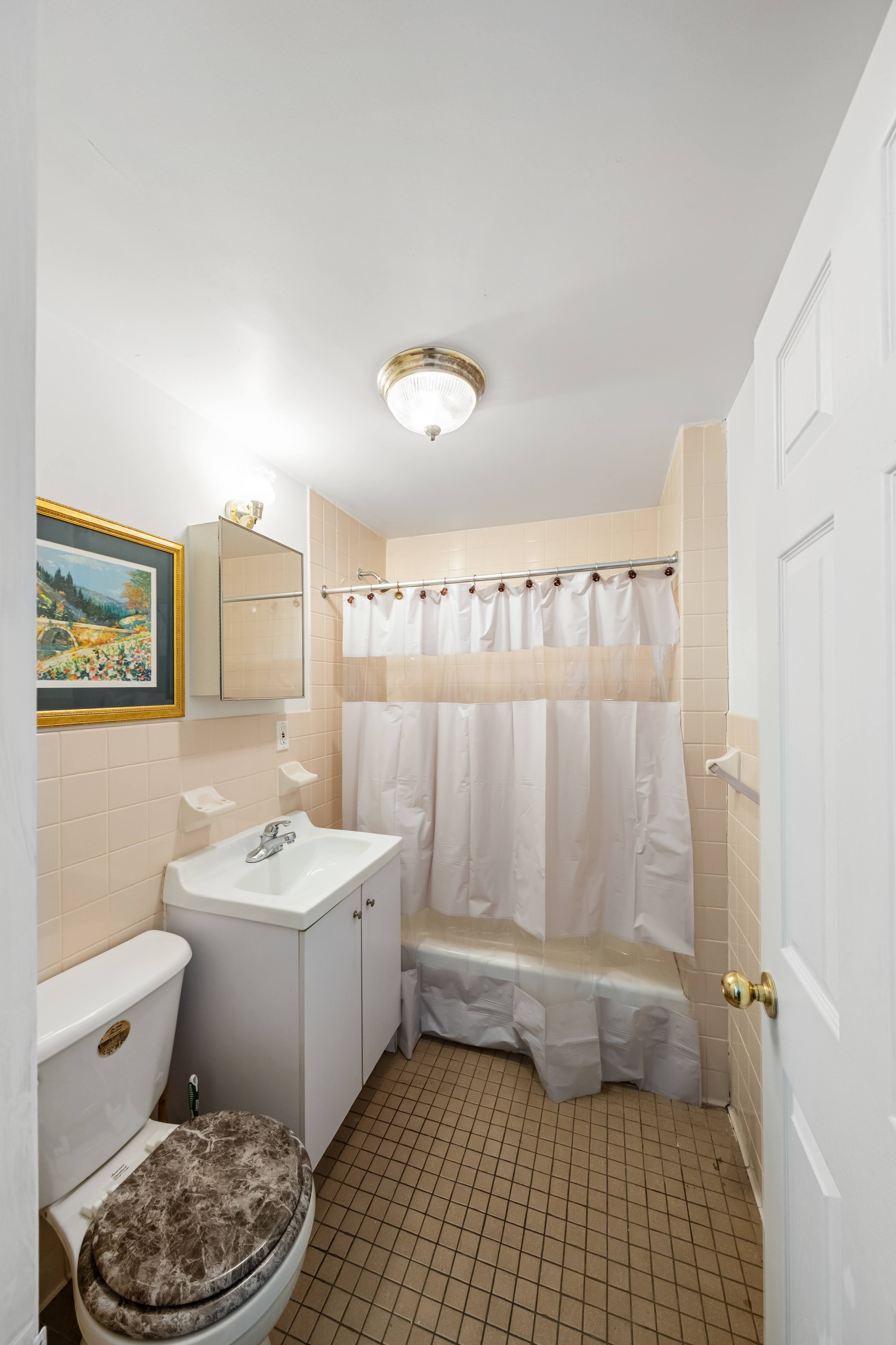 275 Van Buren Street Brooklyn, NY 11221 - Photo 22 of 33 a bathroom with a sink a toilet and shower