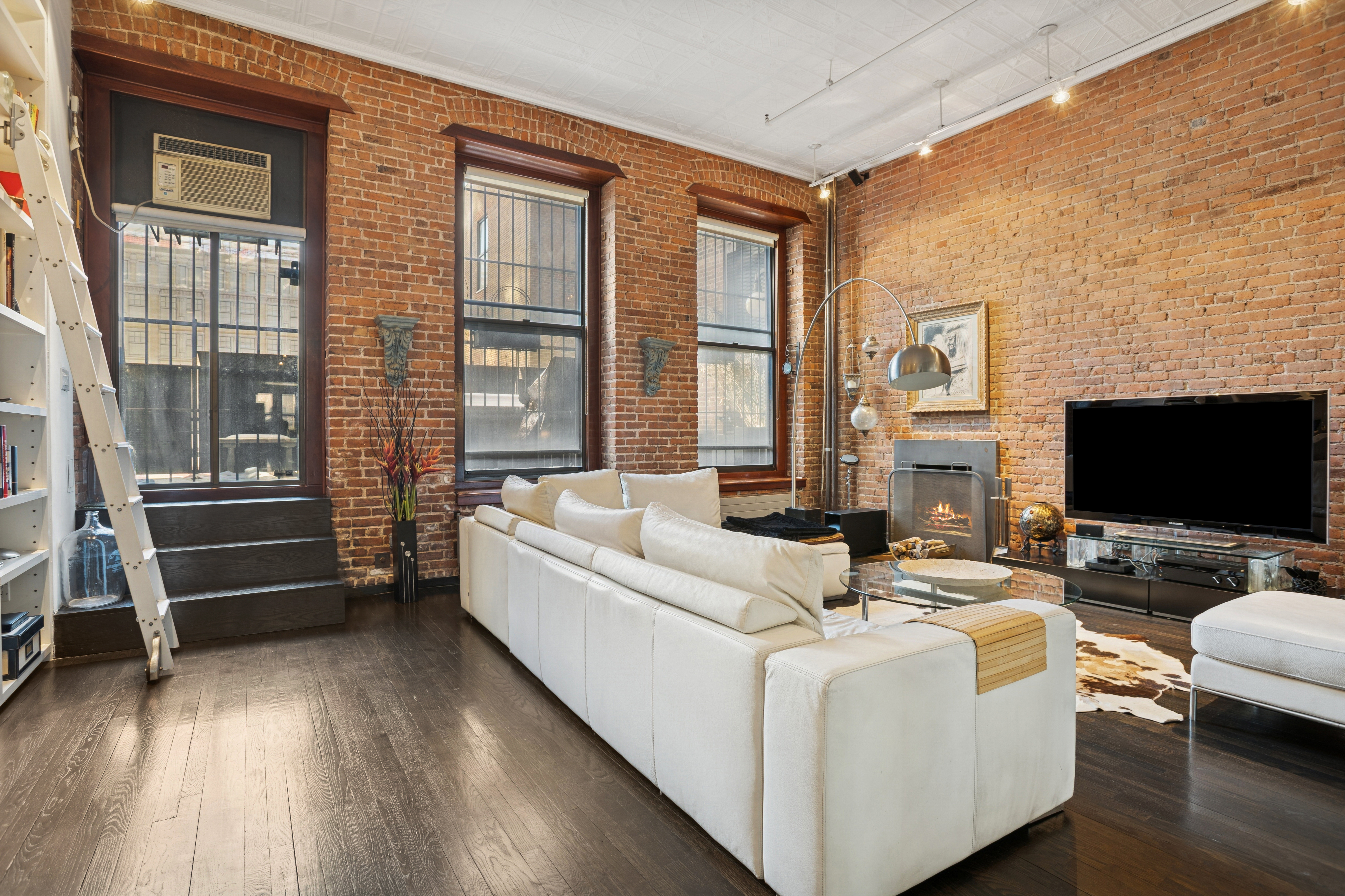 716 Broadway Manhattan, NY 10003 - Photo 14 of 15 a living room with furniture and a flat screen tv
