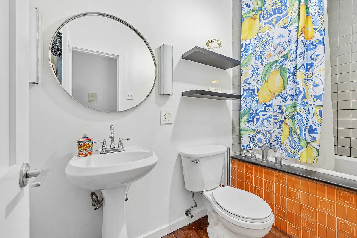 155 Luquer Street, Unit 1 Brooklyn, NY 11231 - Photo 5 of 13 a bathroom with a sink mirror vanity and toilet