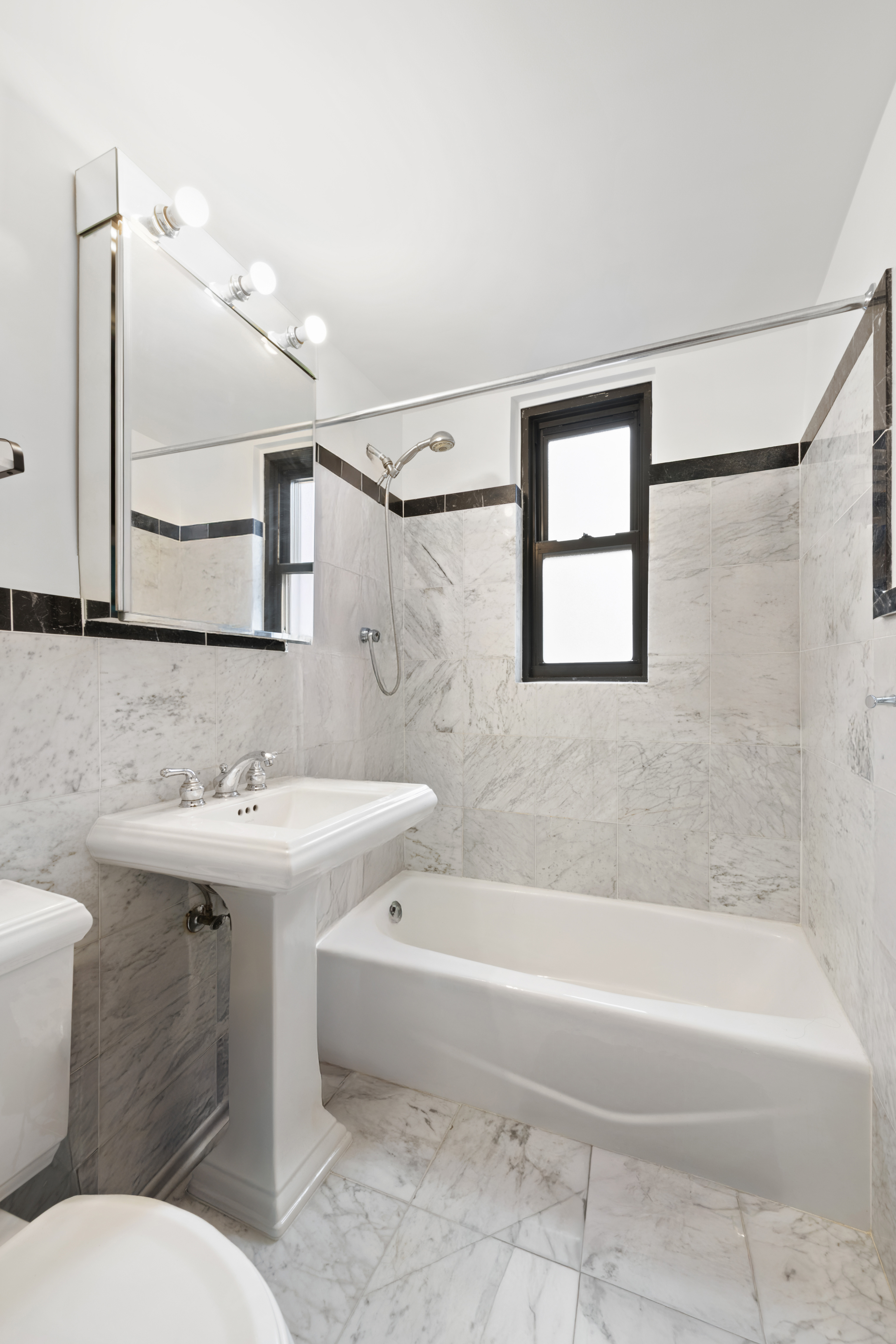 408 West 57th Street, Unit 3A Manhattan, NY 10019 - Photo 6 of 11 a bathroom with a sink mirror toilet and bathtub