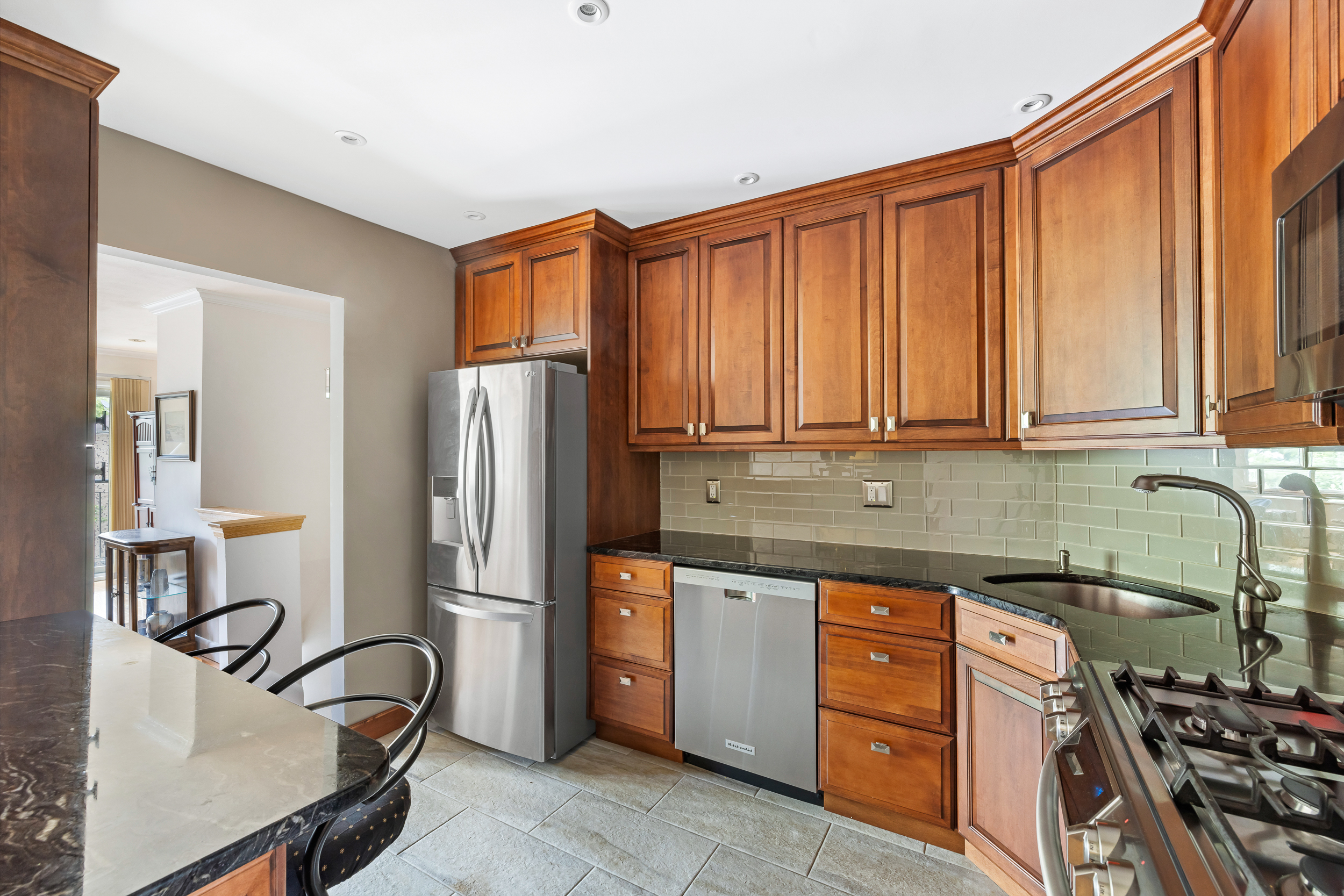 436 78th Street, Unit 5 Brooklyn, NY 11209 - Photo 6 of 10 a kitchen with stainless steel appliances granite countertop a refrigerator and a stove top oven