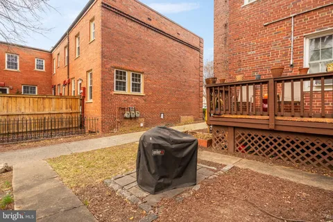 a view of a house with a wooden fence