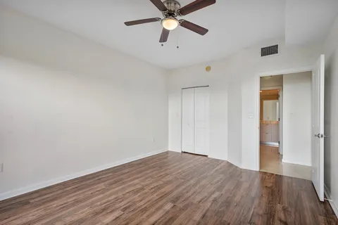a view of empty room with wooden floor