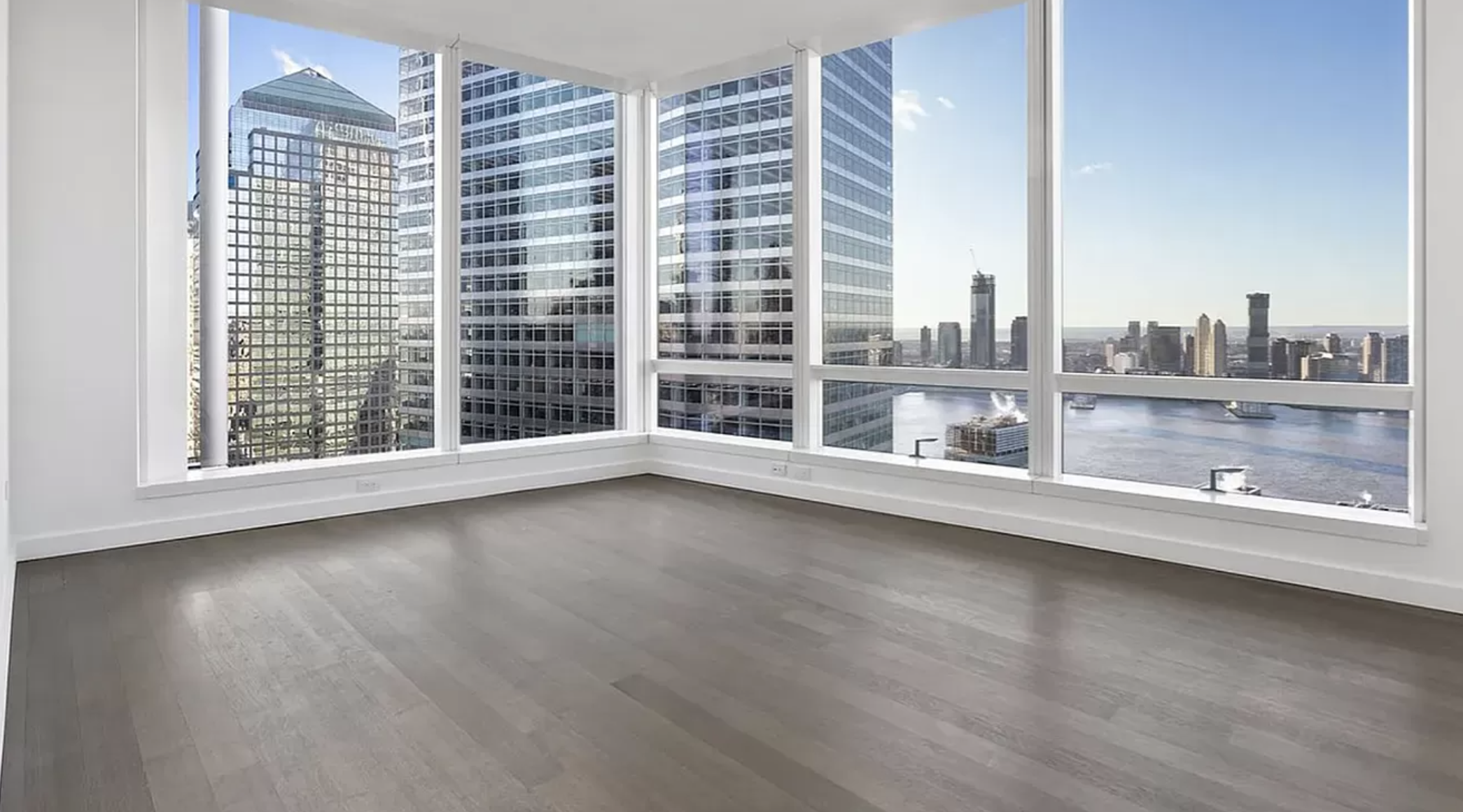 111 Murray Street, Unit 43W Manhattan, NY 10007 - Photo 6 of 32 an empty room with wooden floor and windows