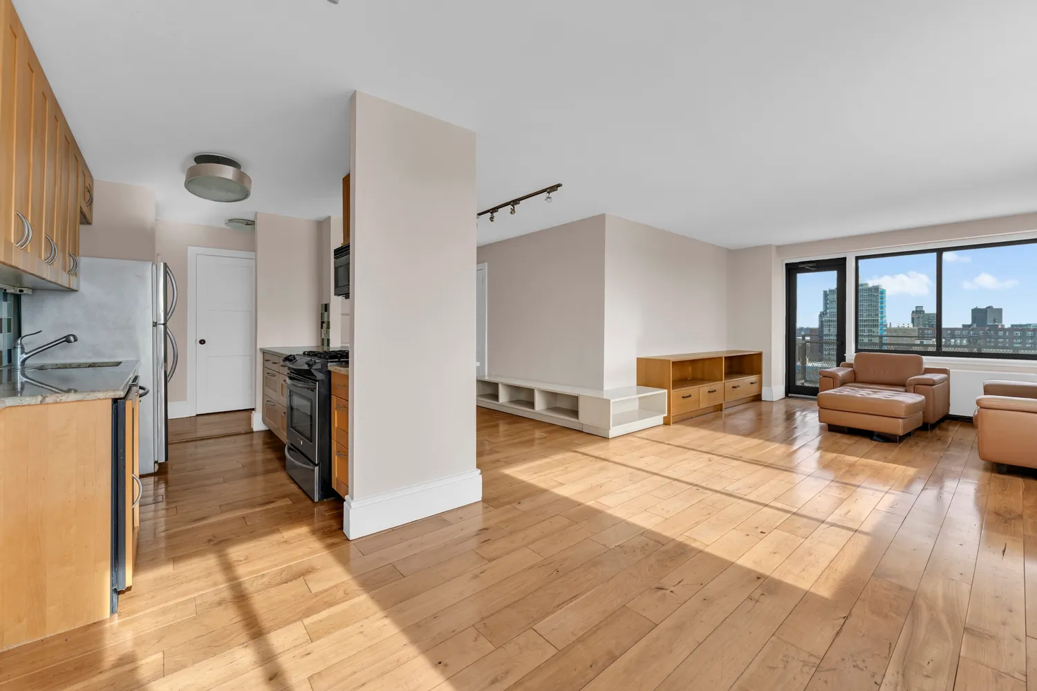 a living room with furniture and a wooden floor