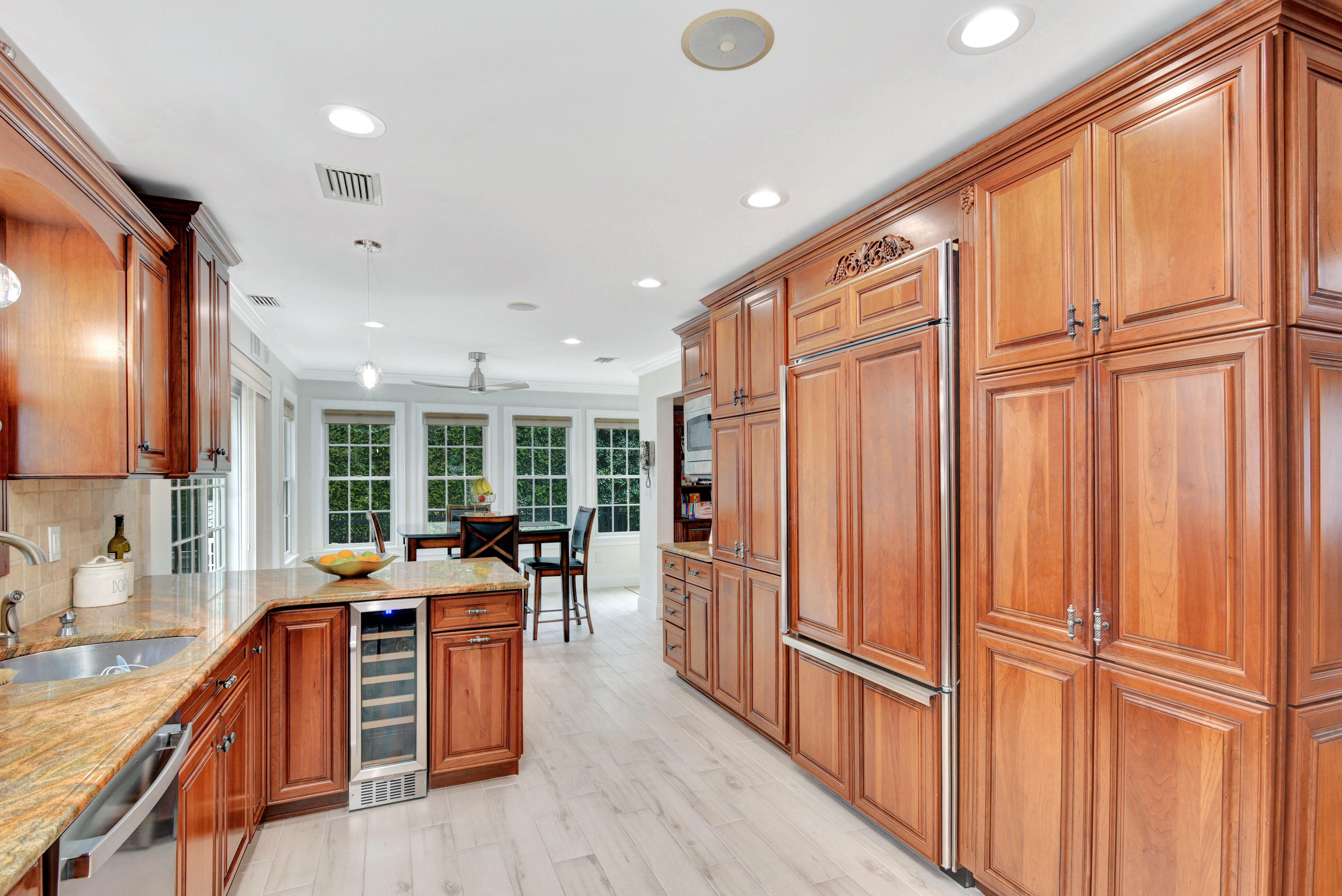 215 Lawrence Avenue Staten Island, NY 10310 - Photo 9 of 45 a kitchen with stainless steel appliances granite countertop a refrigerator a sink dishwasher and wooden cabinets with wooden floor