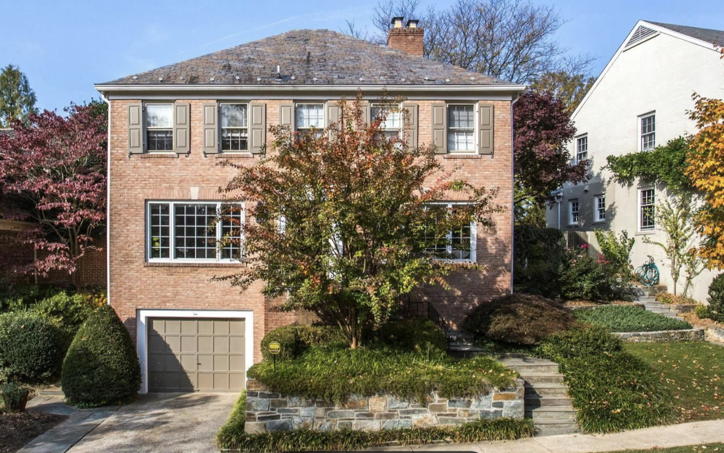 a front view of a house with garden