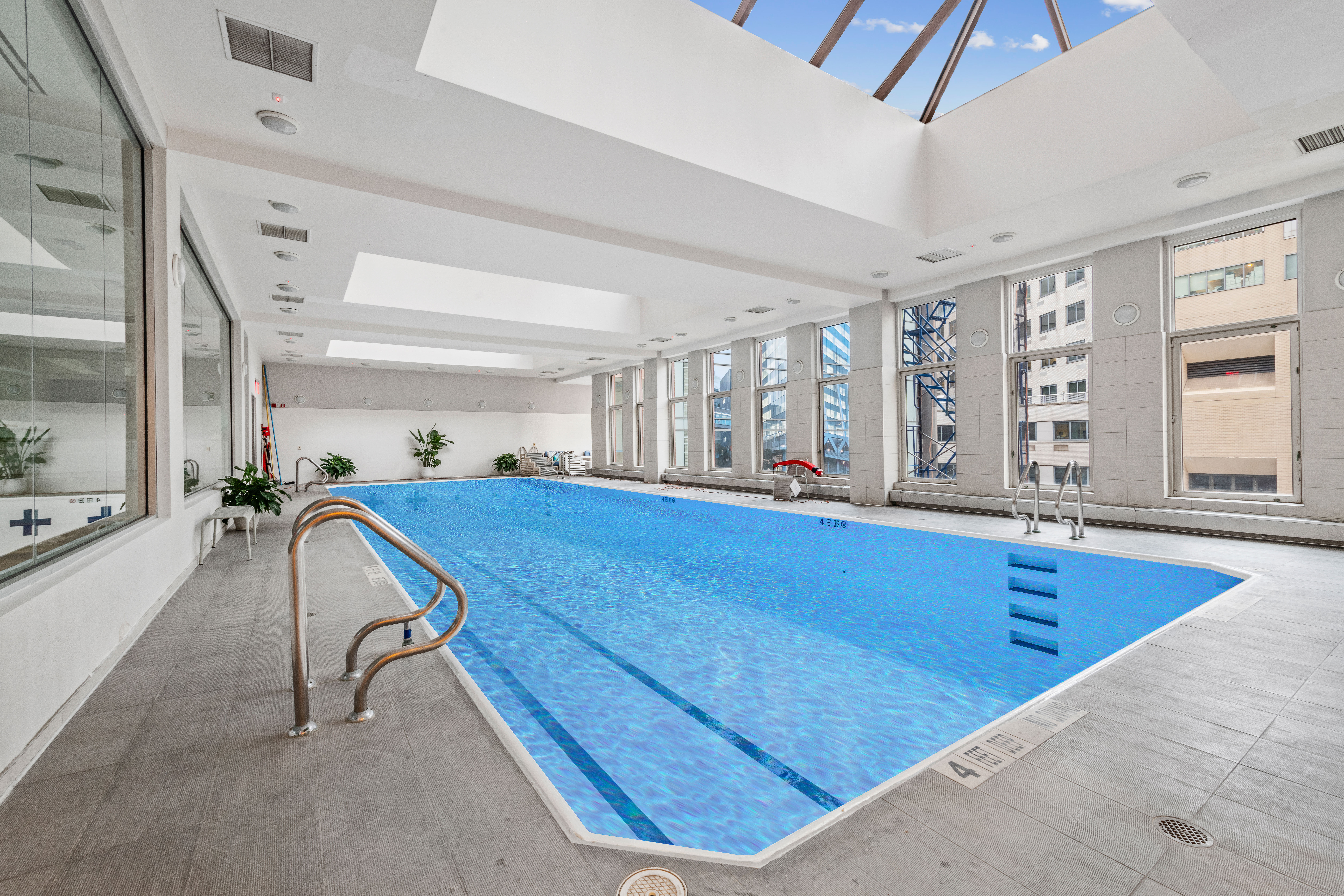 524 East 72nd Street, Unit 24A Manhattan, NY 10021 - Photo 10 of 12 a room with lots of furniture and windows