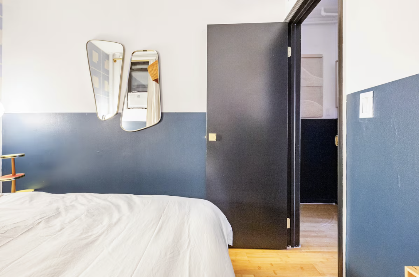 240 Mulberry Street, Unit 2 Manhattan, NY 10012 - Photo 14 of 19 a bedroom with a bed and wooden floor