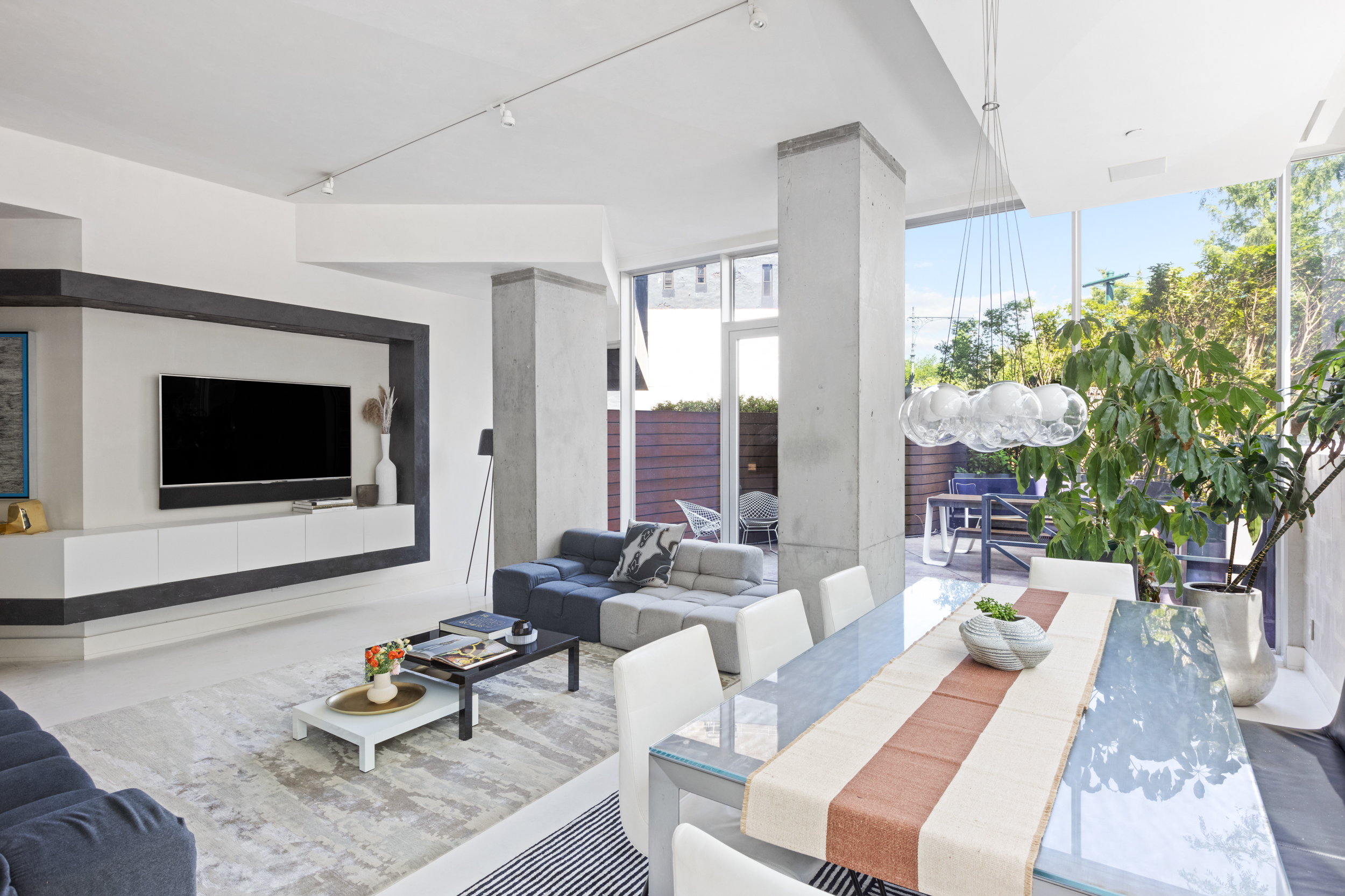 471 Washington Street, Unit 1B Manhattan, NY 10013 - Photo 2 of 17 a living room with furniture and a flat screen tv