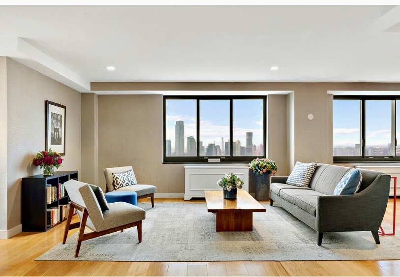 200 Rector Place, Unit 2C Manhattan, NY 10280 - Photo 16 of 19 a living room with furniture and a large window