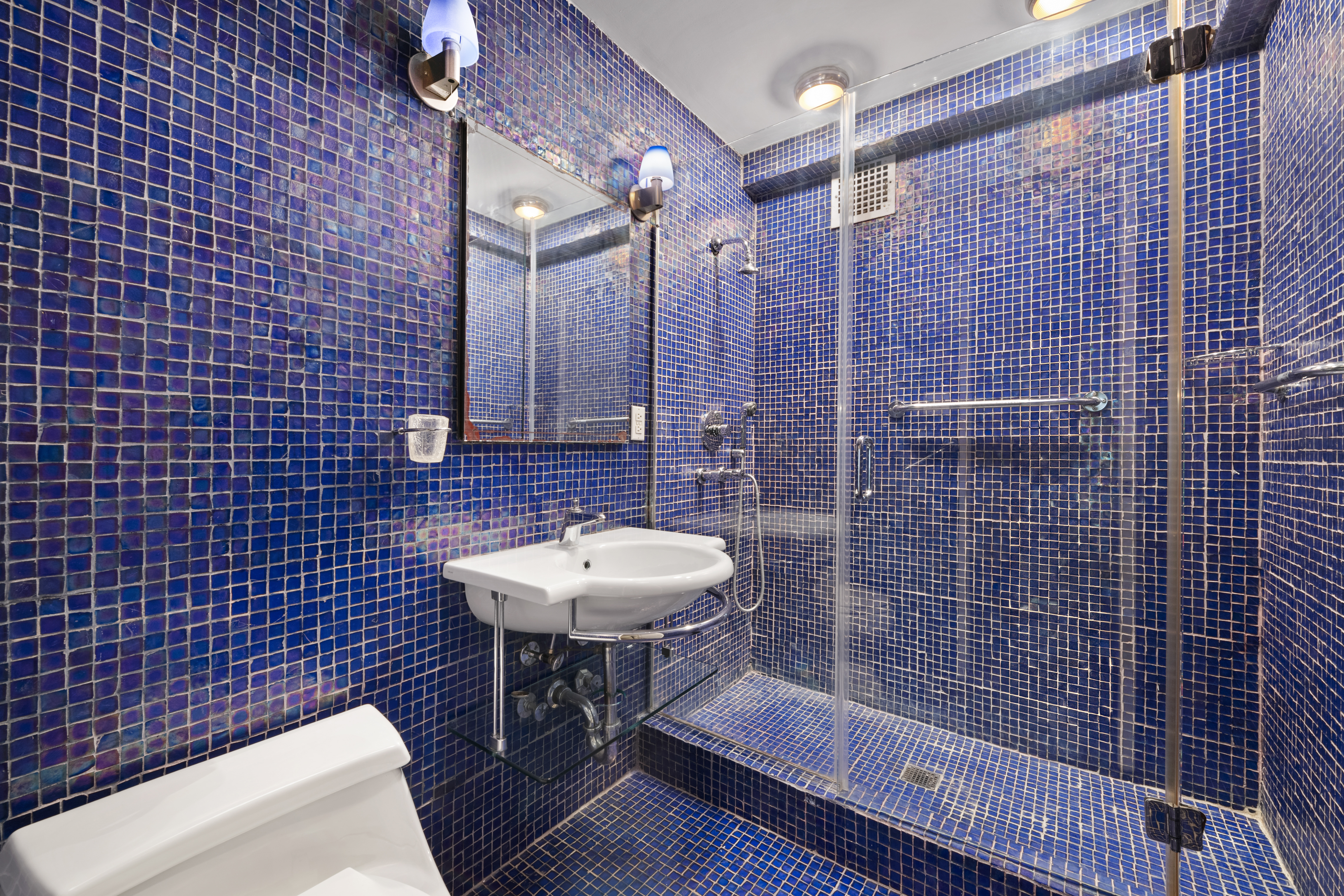 1025 5th Avenue, Unit 7AS Manhattan, NY 10028 - Photo 11 of 16 a bathroom with a sink a toilet and shower