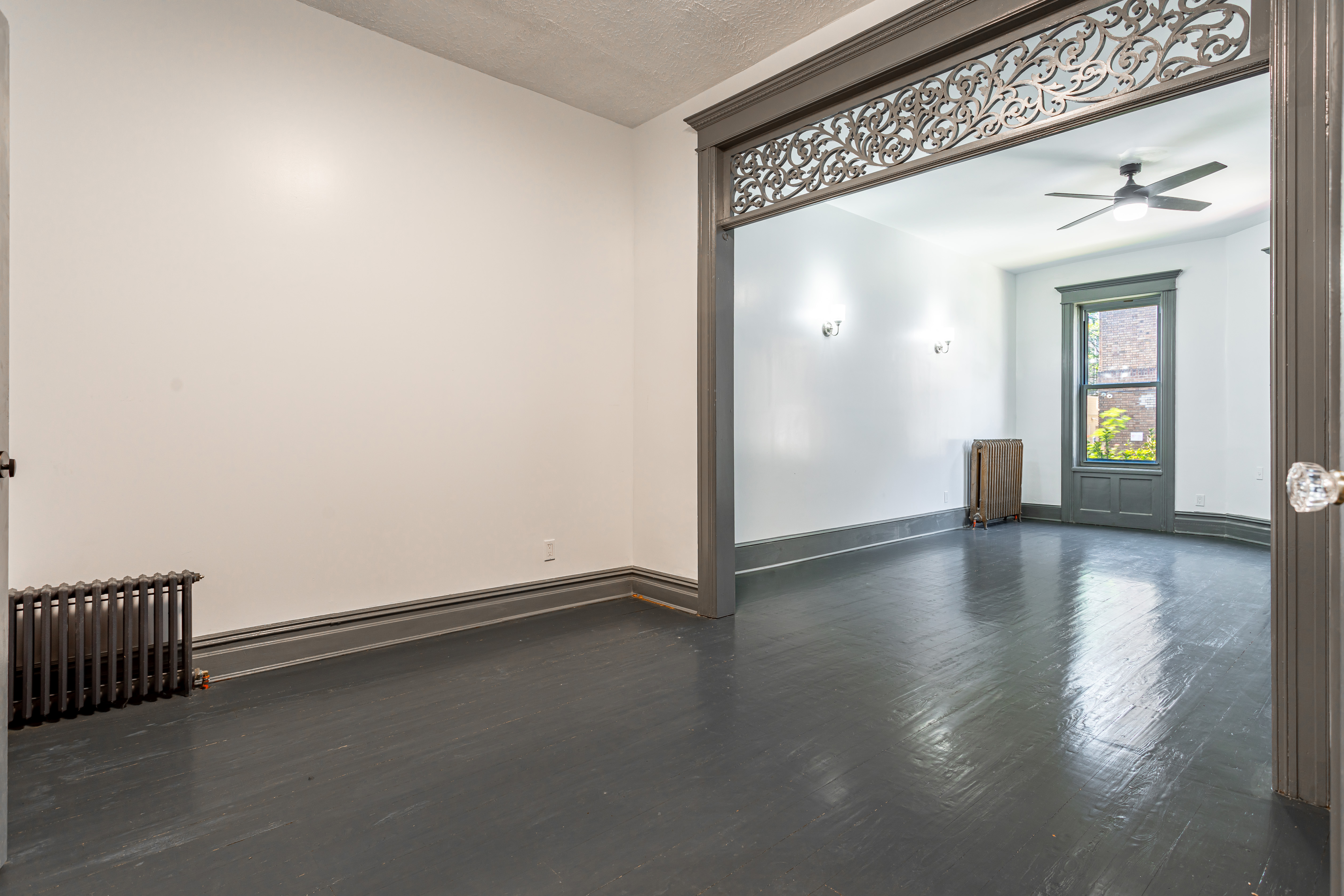 1191 Lincoln Place, Unit 1 Brooklyn, NY 11213 - Photo 3 of 13 an empty room with wooden floor and windows