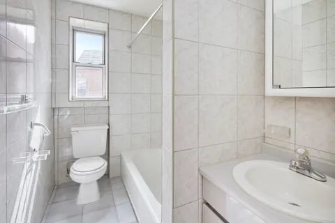 a white toilet sitting next to a bathroom sink