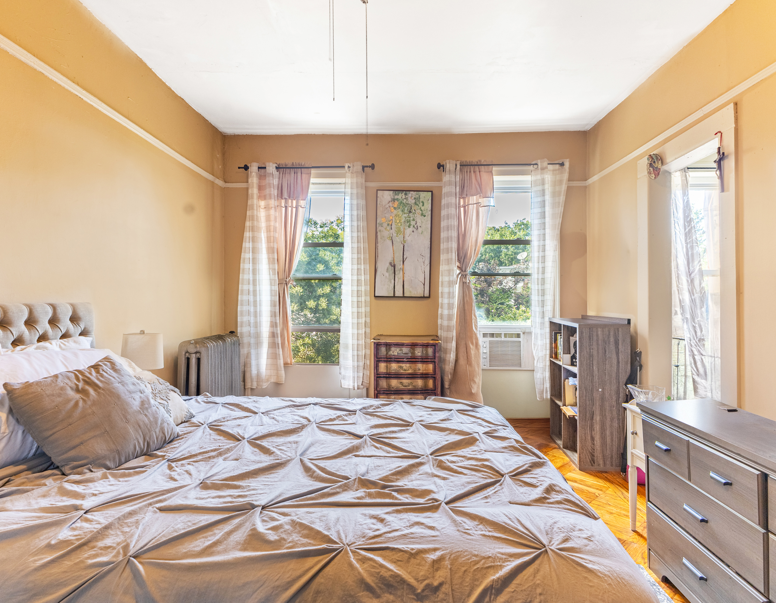 201 Maple Street Brooklyn, NY 11225 - Photo 11 of 21 a bedroom with a large bed and a large window