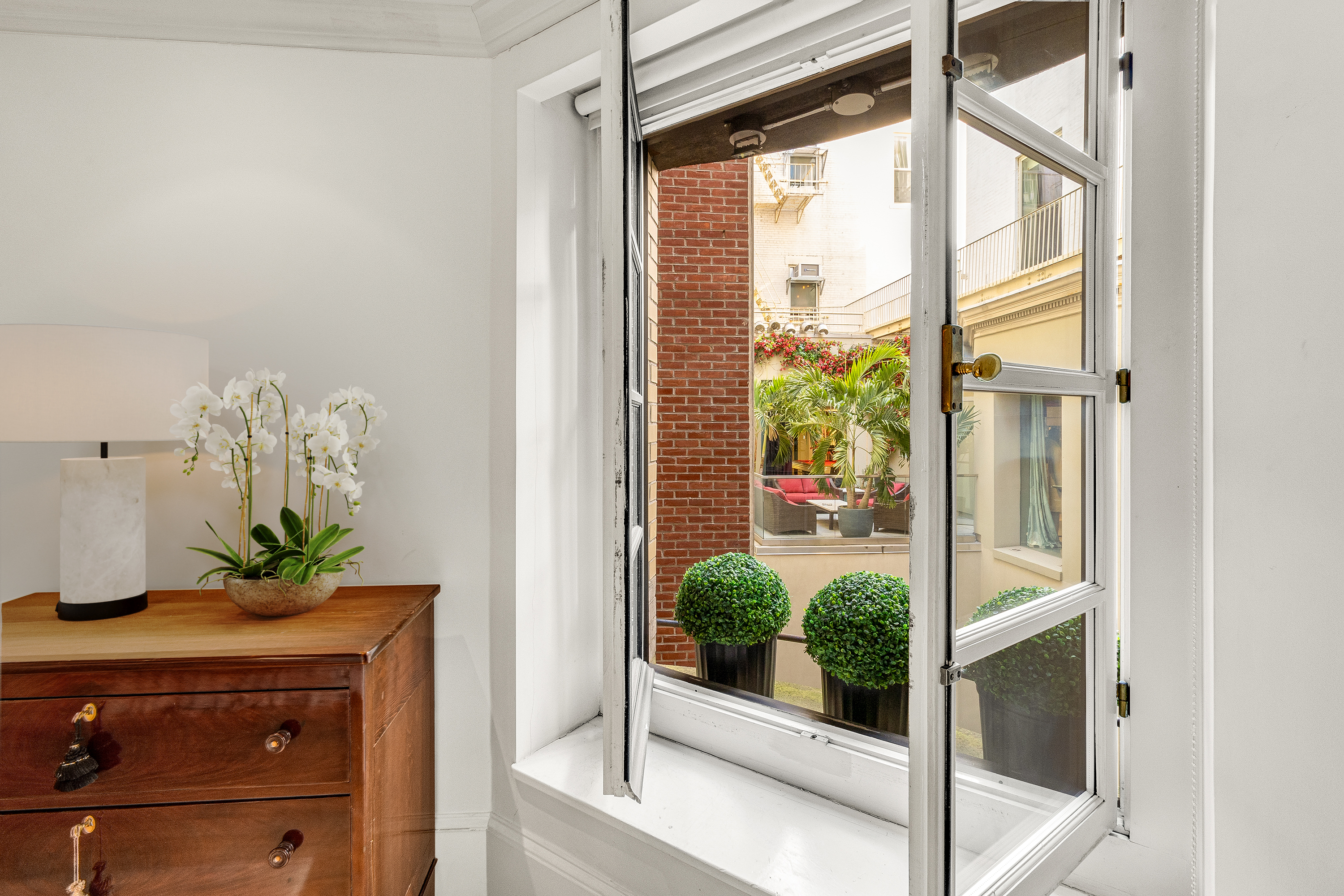 35 East 68th Street, Unit 2A Manhattan, NY 10021 - Photo 7 of 19 a room with a window and potted plant