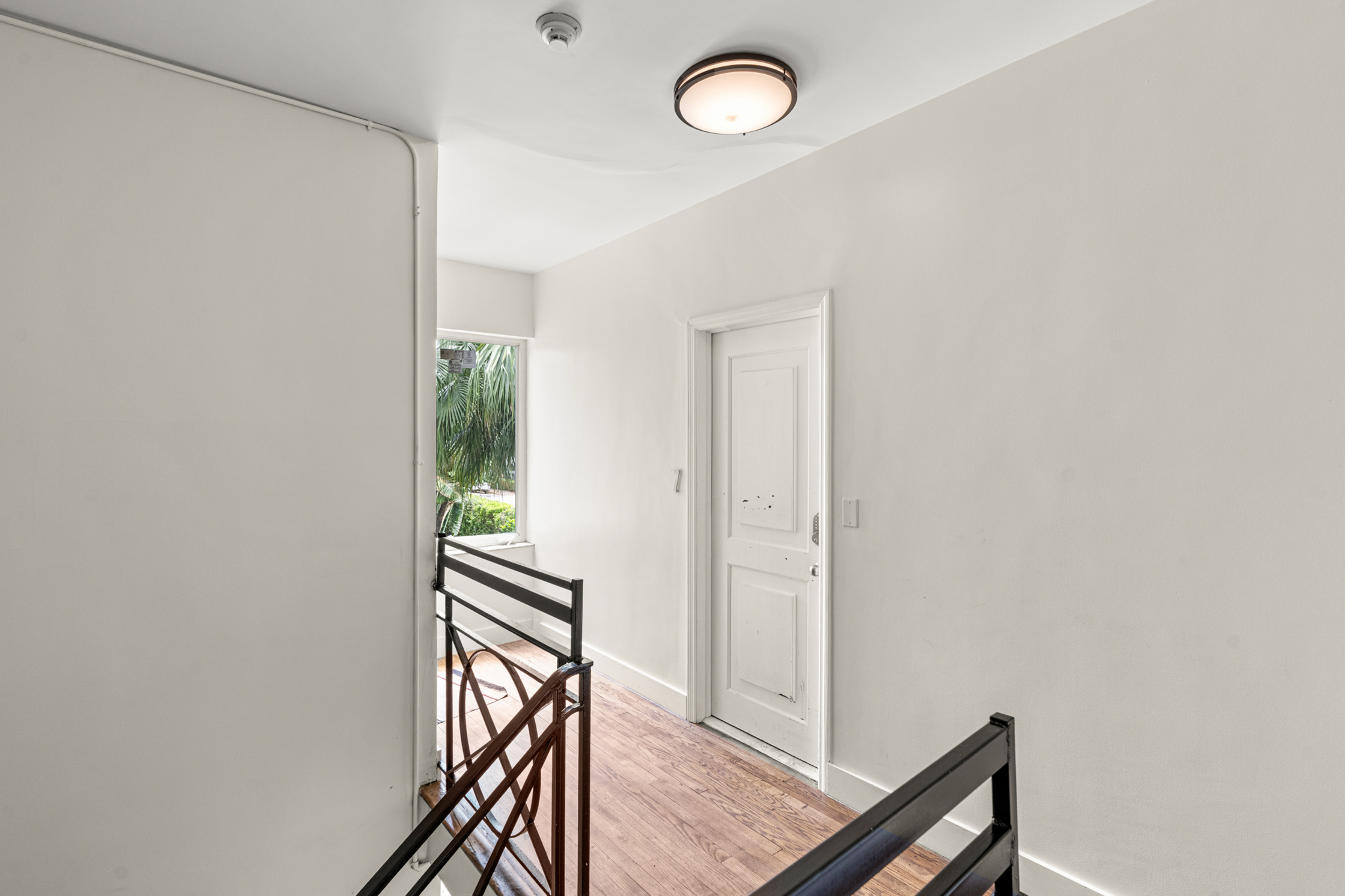 711 East 14th Street, Unit 7 Hialeah, FL 33010 - Photo 6 of 36 a view of a hallway with wooden floor and staircase