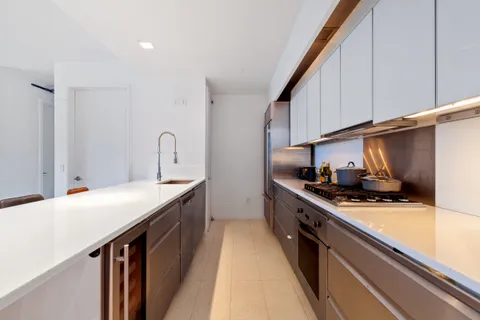 a kitchen with stainless steel appliances a sink stove and cabinets