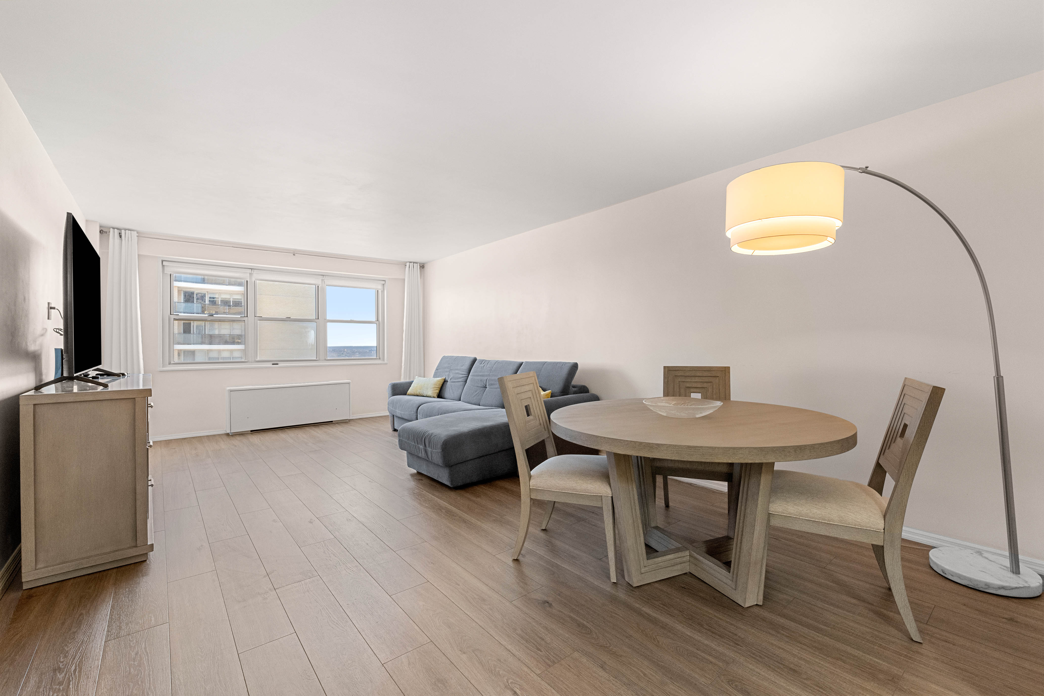 102-10 66th Road, Unit 21K Queens, NY 11375 - Photo 1 of 16 a living room with furniture and a window